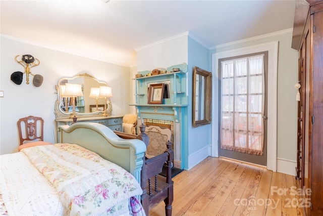 131 E Lexington Rd, Mocksville, NC 27028 - bedroom featuring crown molding, light wood-type flooring, a stone fireplace, and baseboards