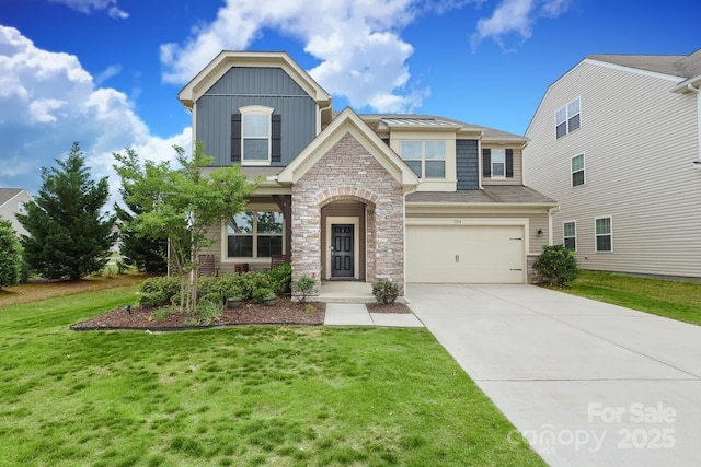 1914 Loggerhead Dr, Lancaster, SC 29720 - view of front of property featuring stone siding, driveway, a front lawn, board and batten siding, and an attached garage