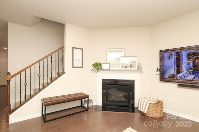 1914 Loggerhead Dr, Lancaster, SC 29720 - living room featuring stairs, wood finished floors, a fireplace with flush hearth, and baseboards