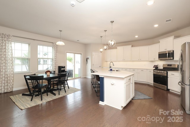 1914 Loggerhead Dr, Lancaster, SC 29720 - kitchen with appliances with stainless steel finishes, a sink, dark wood-style floors, white cabinets, and recessed lighting