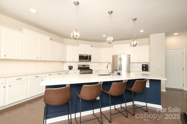 1914 Loggerhead Dr, Lancaster, SC 29720 - kitchen with stainless steel appliances, a sink, a large island, white cabinets, and recessed lighting