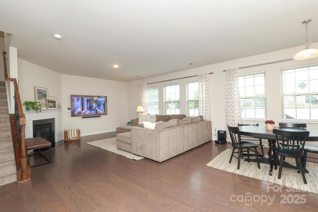 1914 Loggerhead Dr, Lancaster, SC 29720 - living room with wood finished floors, plenty of natural light, a glass covered fireplace, recessed lighting, and baseboards
