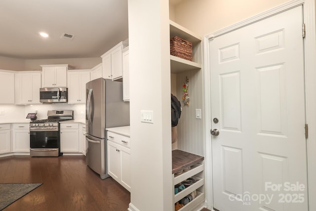 1914 Loggerhead Dr, Lancaster, SC 29720 - kitchen featuring appliances with stainless steel finishes, white cabinetry, light countertops, dark wood-style floors, and recessed lighting