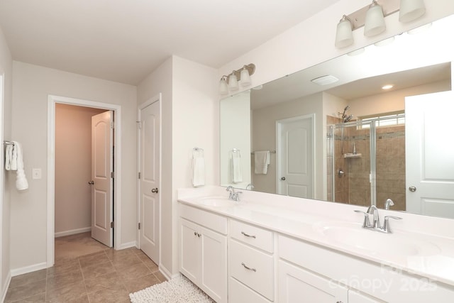 1914 Loggerhead Dr, Lancaster, SC 29720 - bathroom featuring a stall shower, baseboards, double vanity, and tile patterned floors