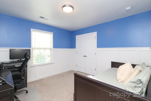 1914 Loggerhead Dr, Lancaster, SC 29720 - bedroom featuring a wainscoted wall, a decorative wall, light colored carpet, a desk, and a closet