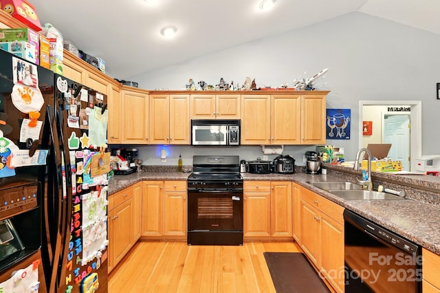 kitchen featuring black appliances, a sink, light wood-type flooring, and high vaulted ceiling