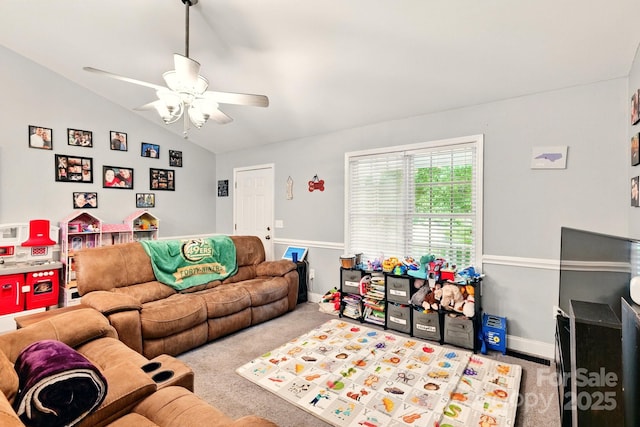 living area with carpet floors, ceiling fan, vaulted ceiling, and baseboards
