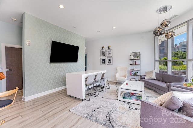 333 W Trade St Unit 1500, Charlotte, NC 28202 - living room featuring an accent wall, light wood-type flooring, wallpapered walls, baseboards, and recessed lighting