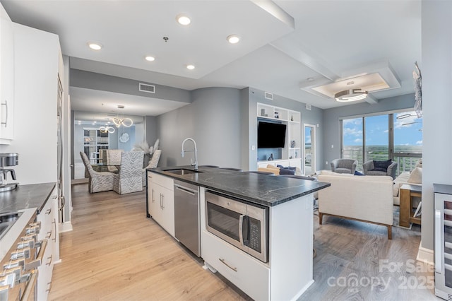 333 W Trade St Unit 1500, Charlotte, NC 28202 - kitchen with stainless steel appliances, a sink, light wood finished floors, white cabinetry, and recessed lighting