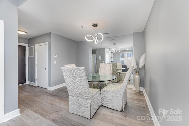 333 W Trade St Unit 1500, Charlotte, NC 28202 - dining space with light wood-style floors and baseboards