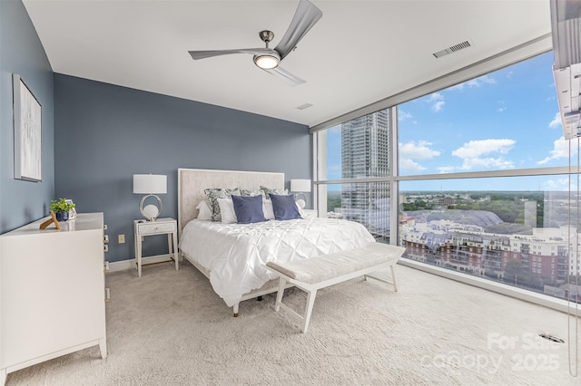 333 W Trade St Unit 1500, Charlotte, NC 28202 - bedroom with floor to ceiling windows, carpet flooring, a city view, and a ceiling fan