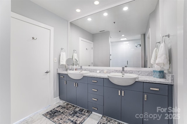 333 W Trade St Unit 1500, Charlotte, NC 28202 - bathroom featuring marble finish floors, a shower stall, recessed lighting, double vanity, and baseboards