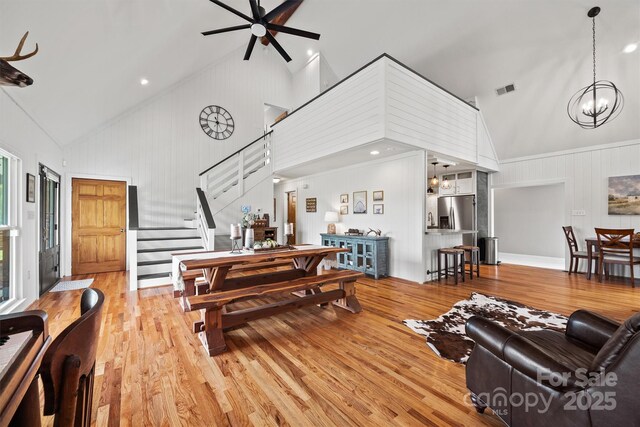 930 Hawley Rd, Mcconnells, SC 29726 - living room with high vaulted ceiling, wood finished floors, stairs, ceiling fan, and a chandelier