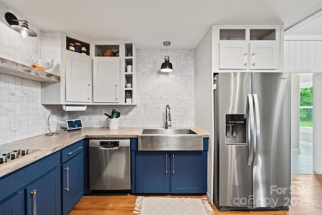 930 Hawley Rd, Mcconnells, SC 29726 - kitchen with stainless steel appliances, open shelves, blue cabinetry, a sink, and backsplash