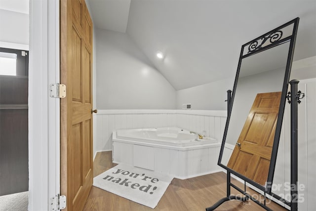 930 Hawley Rd, Mcconnells, SC 29726 - bathroom featuring vaulted ceiling, wood finished floors, and a wainscoted wall