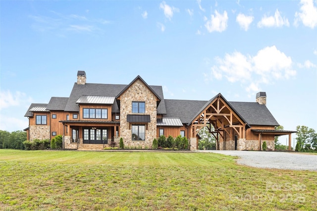 1822 Irby Rd, Monroe, NC 28112 - view of front of home with a standing seam roof, a chimney, stone siding, and a front lawn