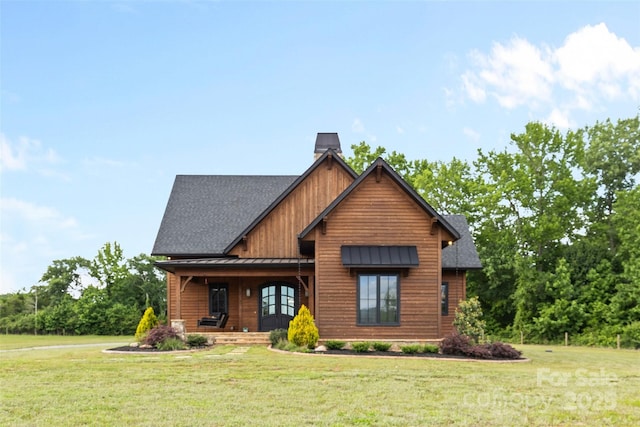 1822 Irby Rd, Monroe, NC 28112 - view of front of property featuring a standing seam roof, a front lawn, covered porch, and a chimney