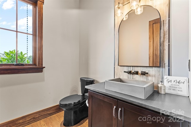 1822 Irby Rd, Monroe, NC 28112 - bathroom with healthy amount of natural light, wood finished floors, vanity, and toilet