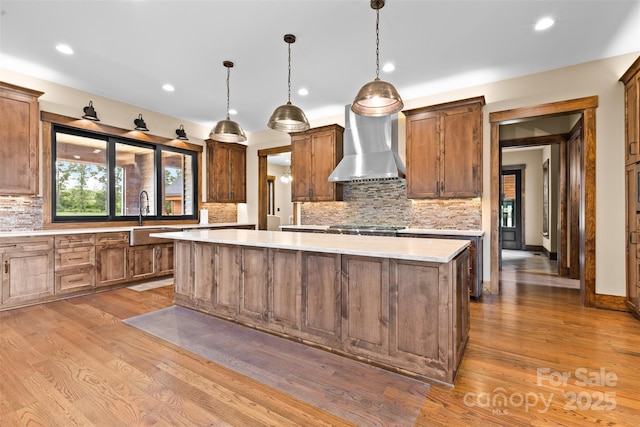 1822 Irby Rd, Monroe, NC 28112 - kitchen with wall chimney range hood, a sink, a center island, decorative backsplash, and recessed lighting