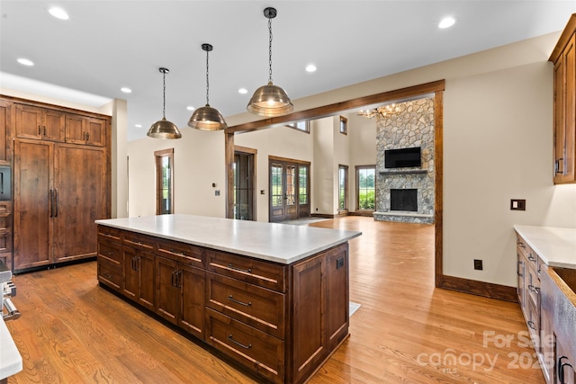 1822 Irby Rd, Monroe, NC 28112 - kitchen with light wood-type flooring, light countertops, recessed lighting, decorative light fixtures, and a center island