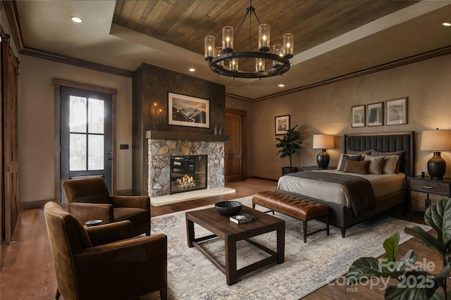 1822 Irby Rd, Monroe, NC 28112 - bedroom featuring a tray ceiling, a chandelier, baseboards, wood finished floors, and crown molding