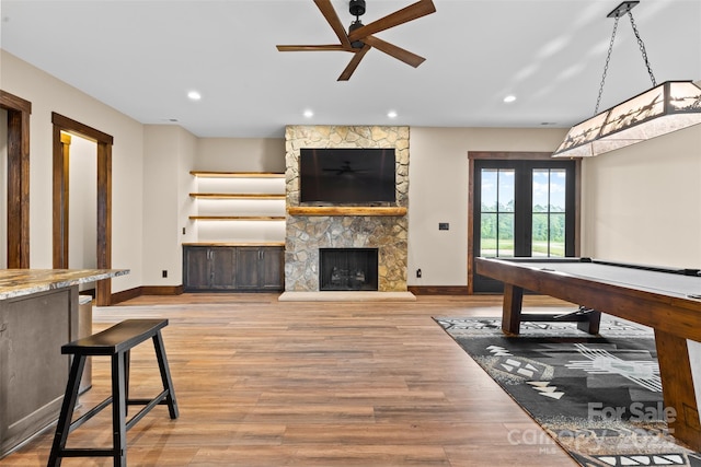 1822 Irby Rd, Monroe, NC 28112 - unfurnished living room featuring baseboards, a ceiling fan, recessed lighting, wood finished floors, and a stone fireplace