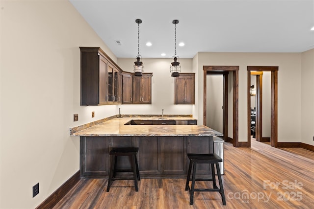 1822 Irby Rd, Monroe, NC 28112 - kitchen with baseboards, dark wood finished floors, dark brown cabinetry, a peninsula, and recessed lighting