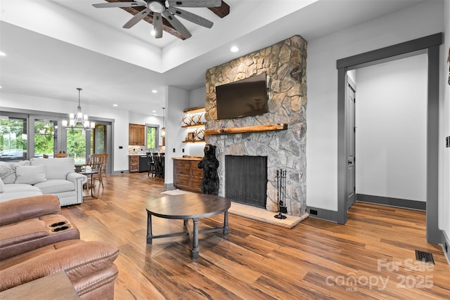 1822 Irby Rd, Monroe, NC 28112 - living area with a ceiling fan, wood finished floors, a fireplace, a chandelier, and baseboards