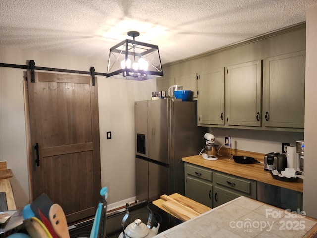 2800 Patio Ln, Gastonia, NC 28056 - kitchen with a barn door, a textured ceiling, butcher block countertops, and stainless steel fridge