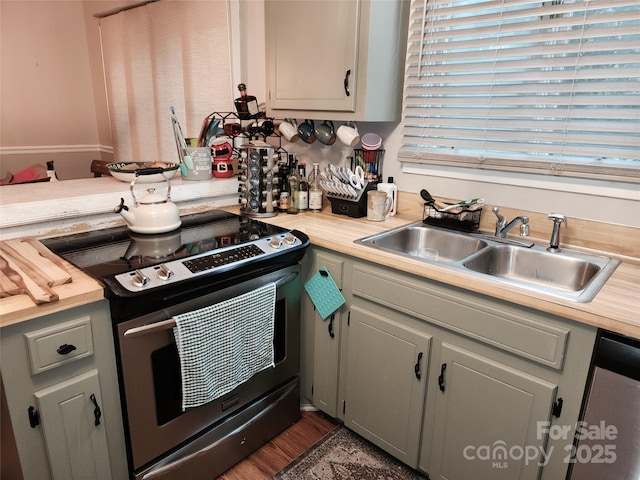 2800 Patio Ln, Gastonia, NC 28056 - kitchen with appliances with stainless steel finishes, a sink, light countertops, and wood finished floors
