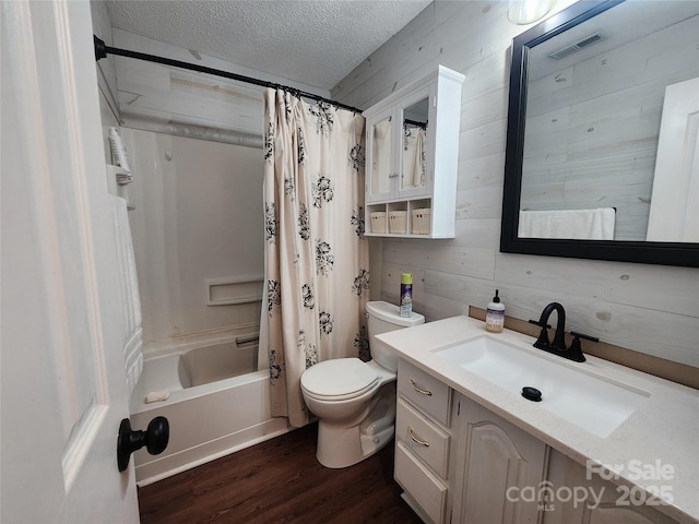 2800 Patio Ln, Gastonia, NC 28056 - bathroom featuring wood finished floors, a textured ceiling, toilet, vanity, and shower / bath combo with shower curtain