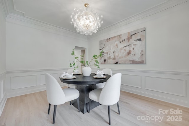 3741 Tea Olive Rd, Gastonia, NC 28056 - dining space featuring a chandelier, light wood finished floors, a decorative wall, a wainscoted wall, and crown molding