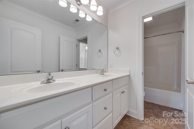 3741 Tea Olive Rd, Gastonia, NC 28056 - bathroom featuring double vanity, ornamental molding, washtub / shower combination, and toilet