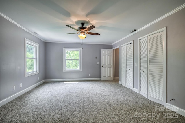 6470 Stone Mountain Rd, Lenoir, NC 28645 - unfurnished bedroom with carpet, crown molding, two closets, baseboards, and a ceiling fan