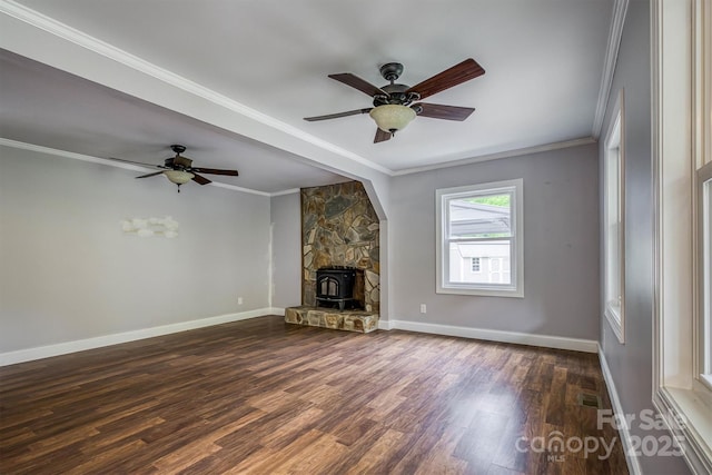 6470 Stone Mountain Rd, Lenoir, NC 28645 - unfurnished living room featuring dark wood-style flooring, a wood stove, a ceiling fan, baseboards, and ornamental molding
