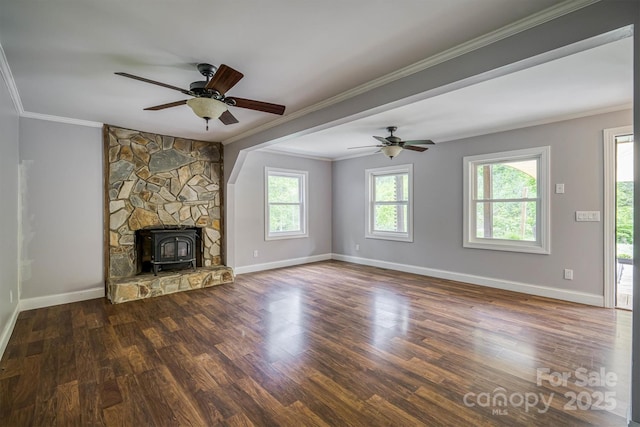 6470 Stone Mountain Rd, Lenoir, NC 28645 - unfurnished living room with a wood stove, wood finished floors, ceiling fan, ornamental molding, and baseboards