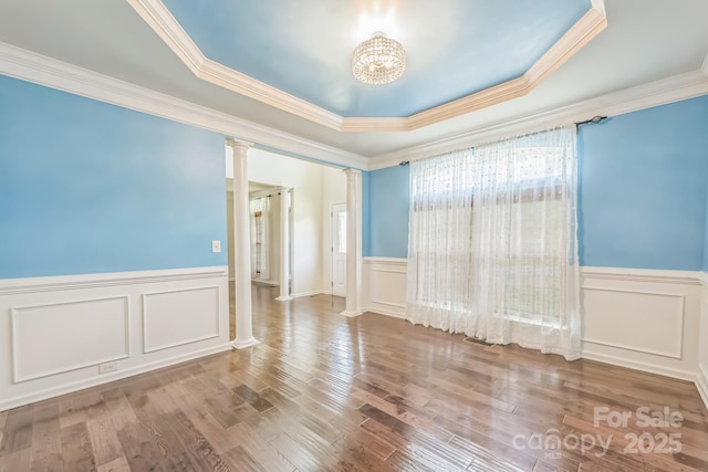 8336 Early Bird Way, Mint Hill, NC 28227 - spare room with decorative columns, a tray ceiling, a wainscoted wall, a decorative wall, and crown molding