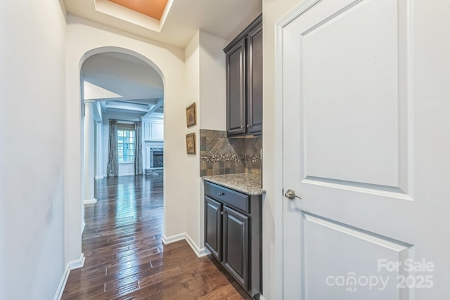 8336 Early Bird Way, Mint Hill, NC 28227 - bar featuring arched walkways, dark wood-type flooring, backsplash, and baseboards