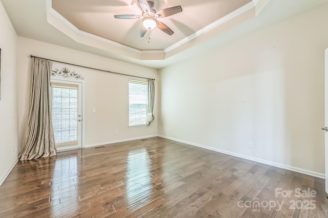 8336 Early Bird Way, Mint Hill, NC 28227 - unfurnished room with a tray ceiling, crown molding, wood finished floors, a ceiling fan, and baseboards