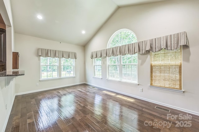 8336 Early Bird Way, Mint Hill, NC 28227 - unfurnished living room with plenty of natural light, dark wood-style flooring, high vaulted ceiling, baseboards, and recessed lighting
