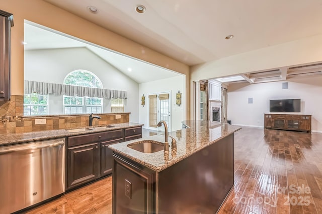 8336 Early Bird Way, Mint Hill, NC 28227 - kitchen featuring stainless steel dishwasher, a sink, open floor plan, vaulted ceiling, and light wood-type flooring