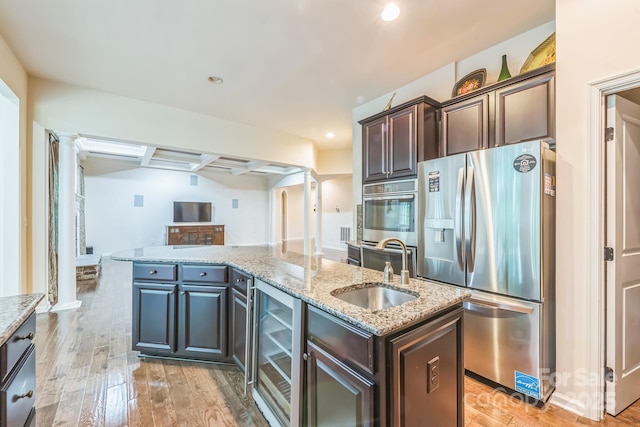 8336 Early Bird Way, Mint Hill, NC 28227 - kitchen featuring stainless steel fridge, beverage cooler, a sink, a kitchen island with sink, and light wood-type flooring