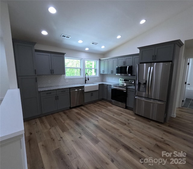 280 Haven Ridge Ln N, Marion, NC 28752 - kitchen featuring appliances with stainless steel finishes, a sink, decorative backsplash, wood finished floors, and recessed lighting