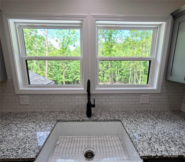 280 Haven Ridge Ln N, Marion, NC 28752 - kitchen view of decorative backsplash, a sink, and light stone counters