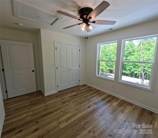 280 Haven Ridge Ln N, Marion, NC 28752 - unfurnished bedroom featuring baseboards, wood finished floors, a closet, and a ceiling fan