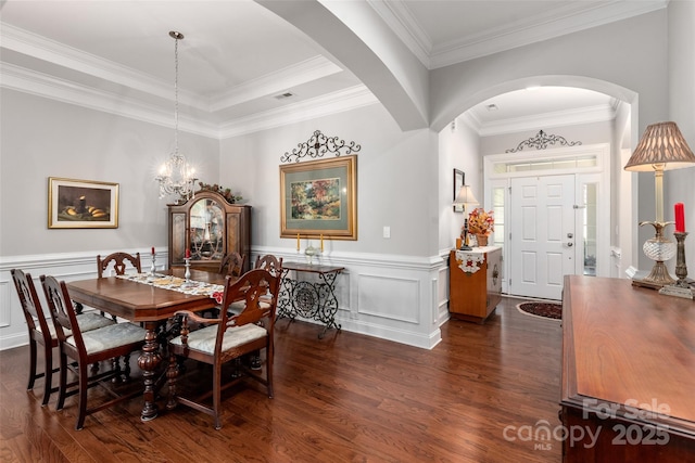 2021 Pinyon Ln, Lancaster, SC 29720 - dining area featuring dark wood finished floors, a chandelier, arched walkways, wainscoting, and ornamental molding