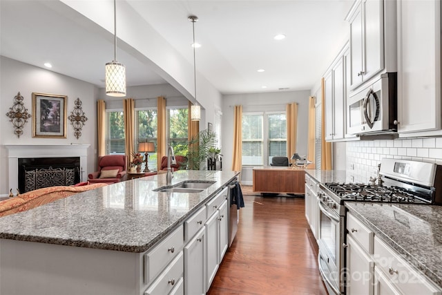 2021 Pinyon Ln, Lancaster, SC 29720 - kitchen featuring stainless steel appliances, open floor plan, a sink, dark wood-style floors, and white cabinets