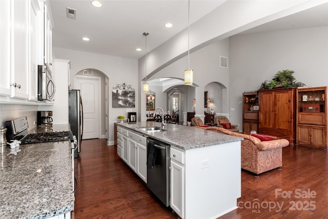 2021 Pinyon Ln, Lancaster, SC 29720 - kitchen featuring arched walkways, stainless steel appliances, a sink, open floor plan, and white cabinets