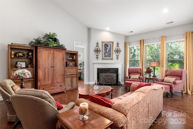 2021 Pinyon Ln, Lancaster, SC 29720 - living room featuring dark wood finished floors, vaulted ceiling, a fireplace, and recessed lighting