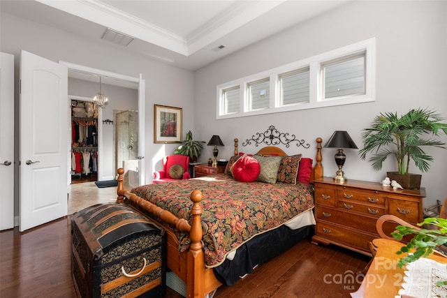 2021 Pinyon Ln, Lancaster, SC 29720 - bedroom with hardwood / wood-style floors, a walk in closet, a closet, a chandelier, and crown molding